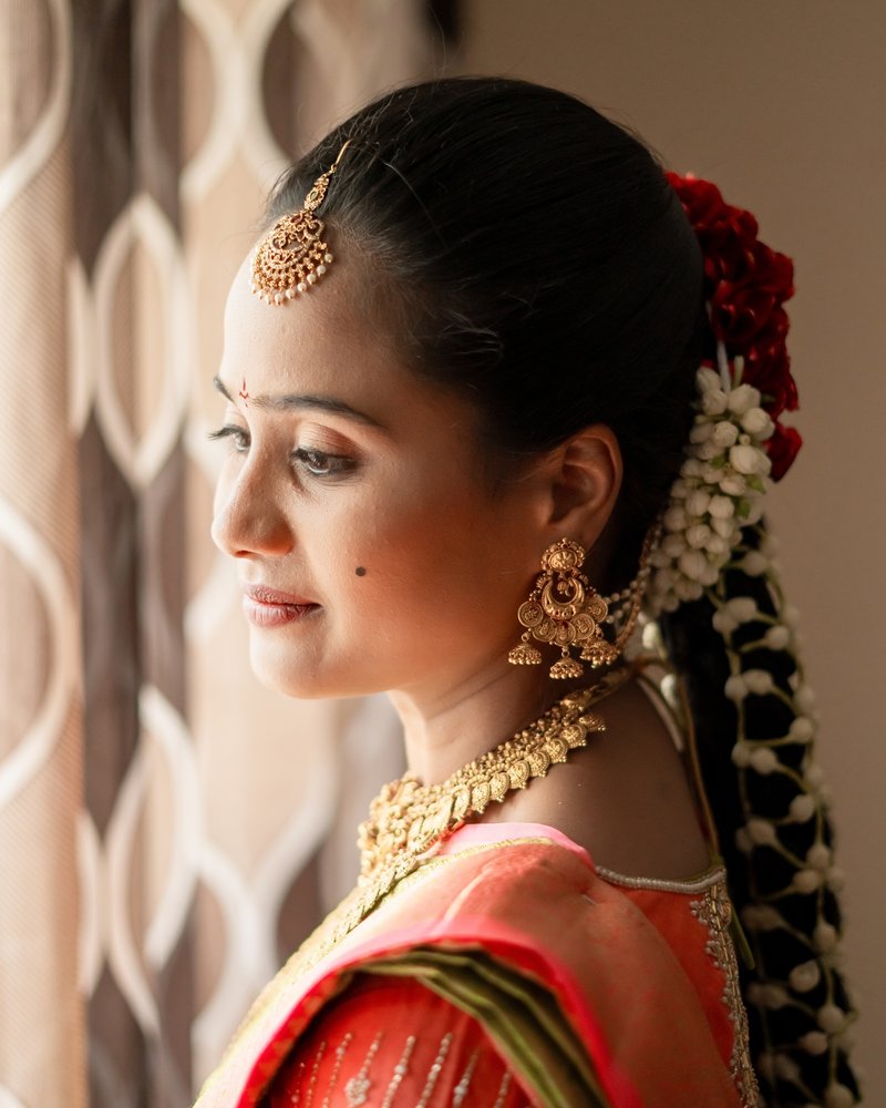 Bridal makeup with floral hair styling, window light