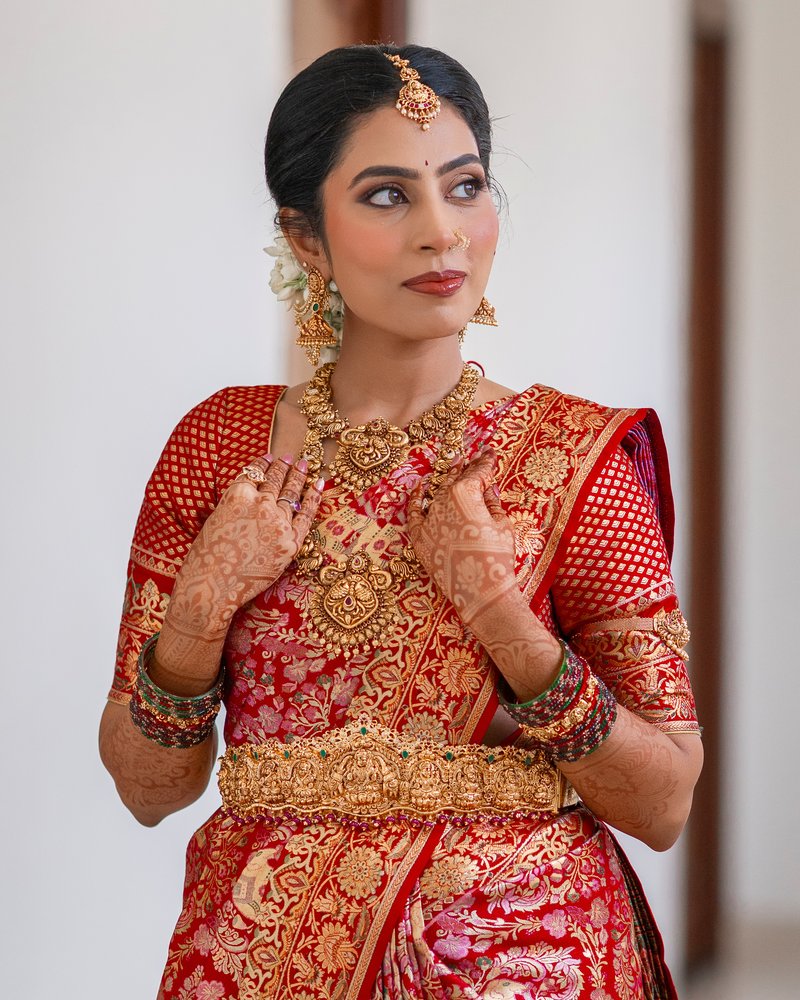 Bridal makeup with traditional gold jewelry and mehendi